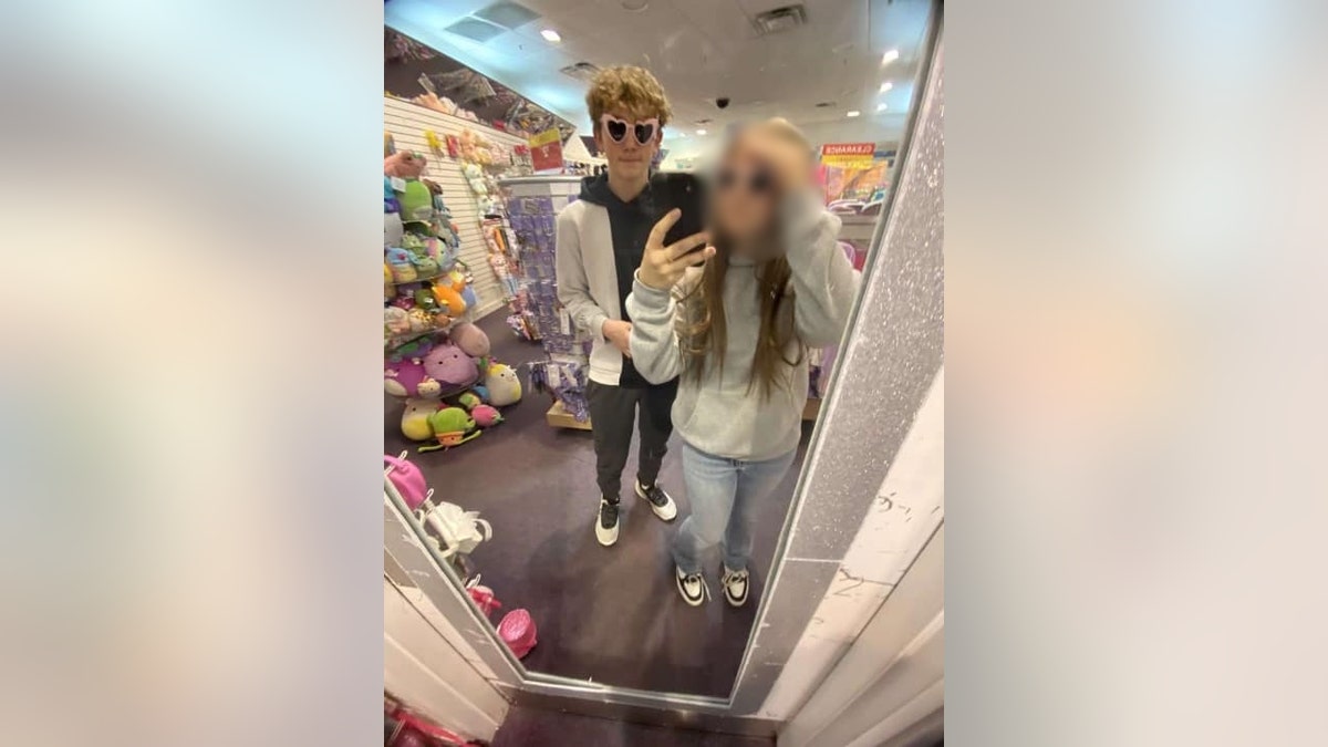 Bobby Maher and his girlfriend take a photo in a mirror