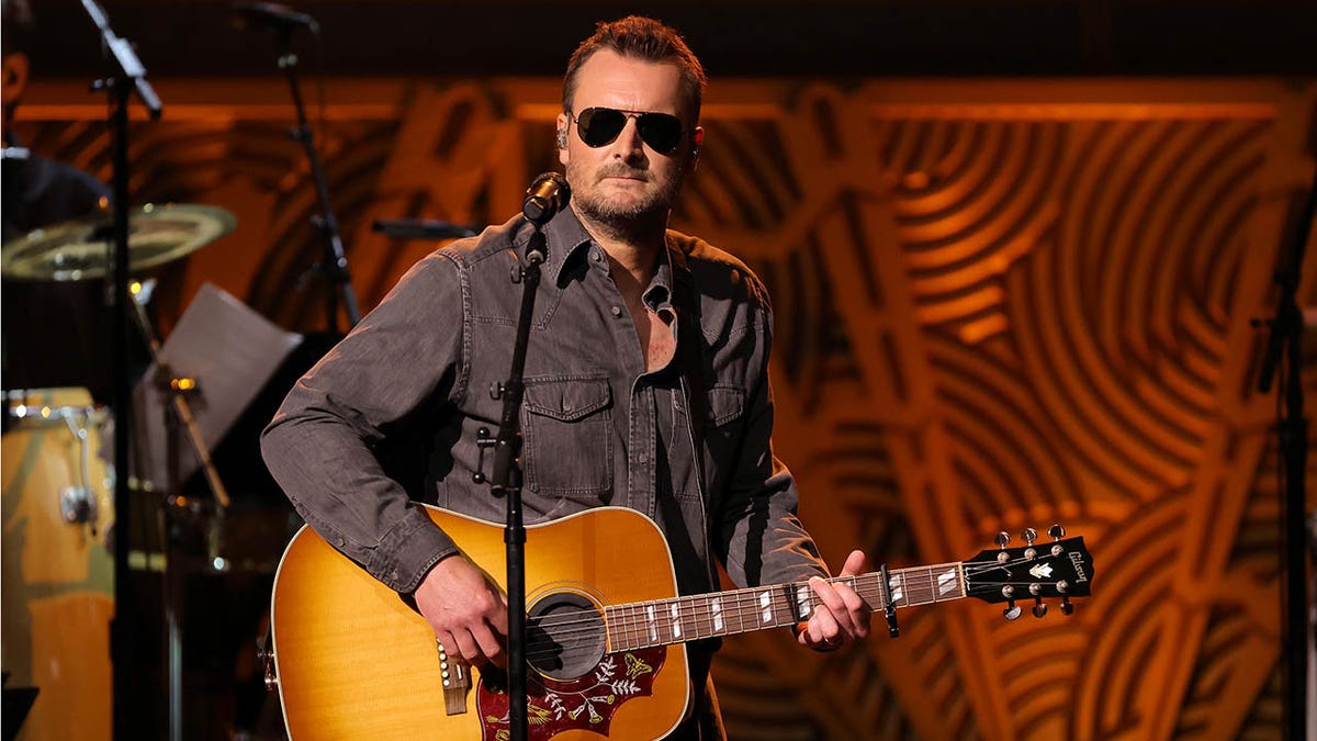 eric church playing the guitar on stage