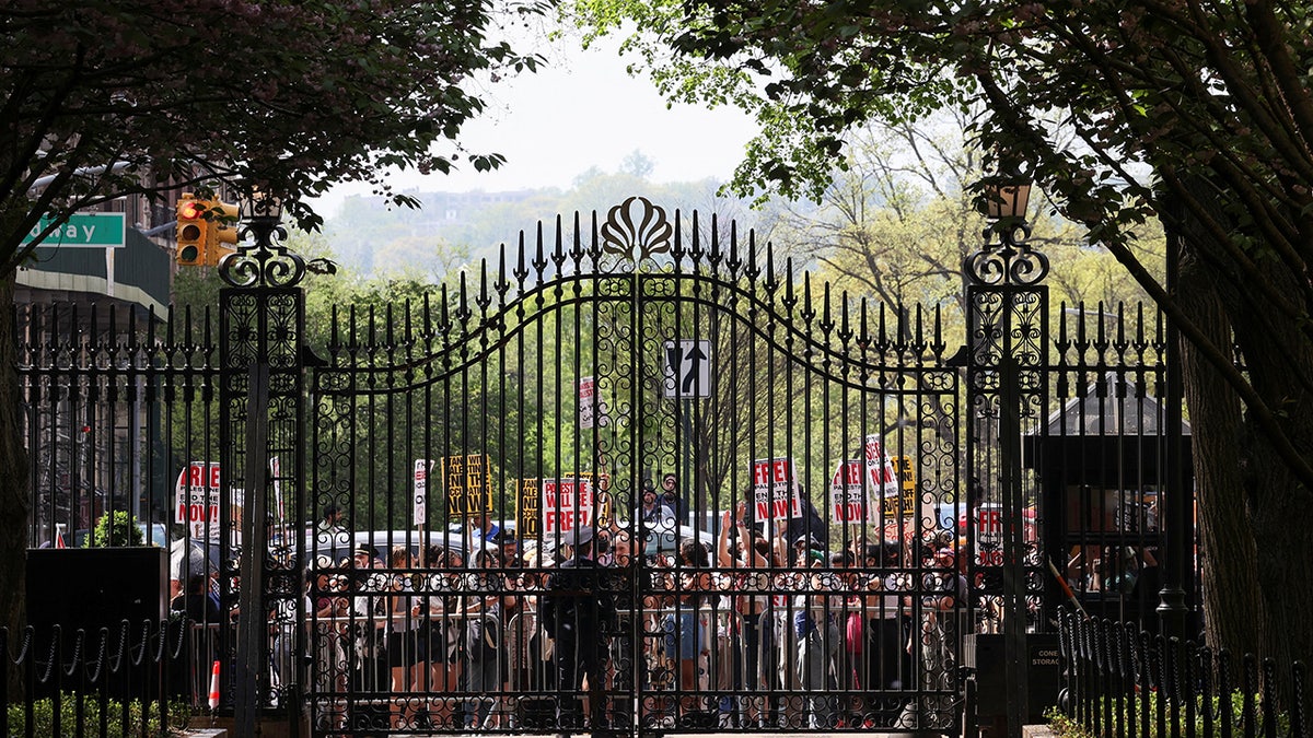 Demonstrators gather outside the main entrance to Columbia University