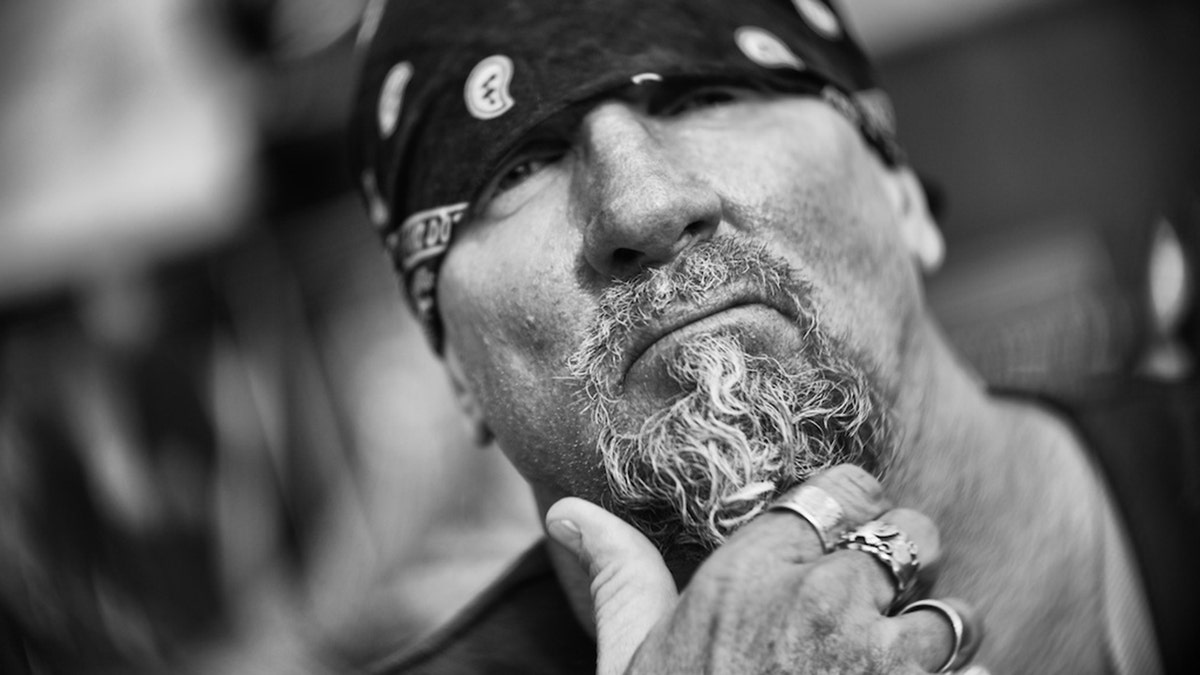 A black and white close-up of Jay Dobyns wearing a bandana