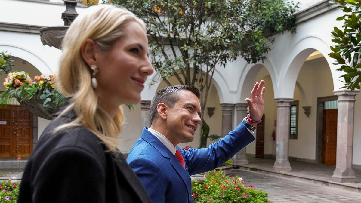 Ecuador president and first lady waving