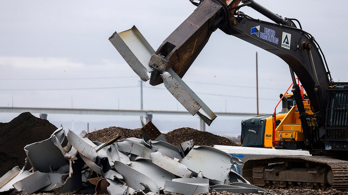 Crane lifting a metal section of the bridge