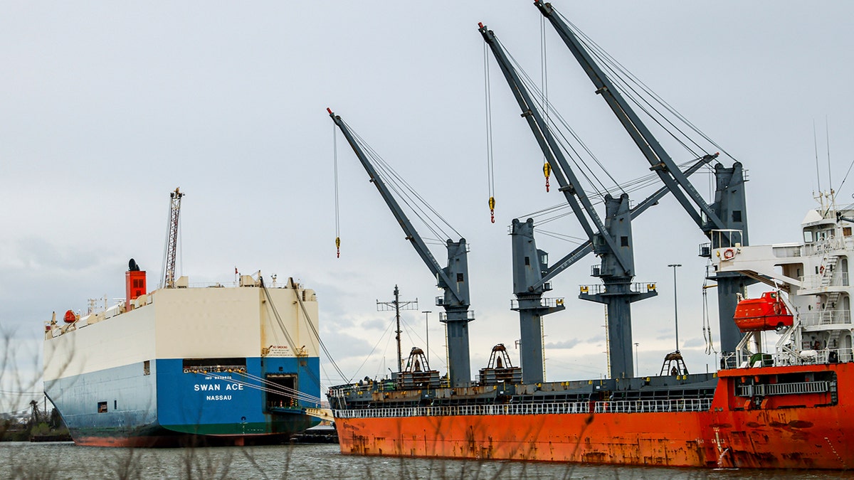 A photo of ships, cranes