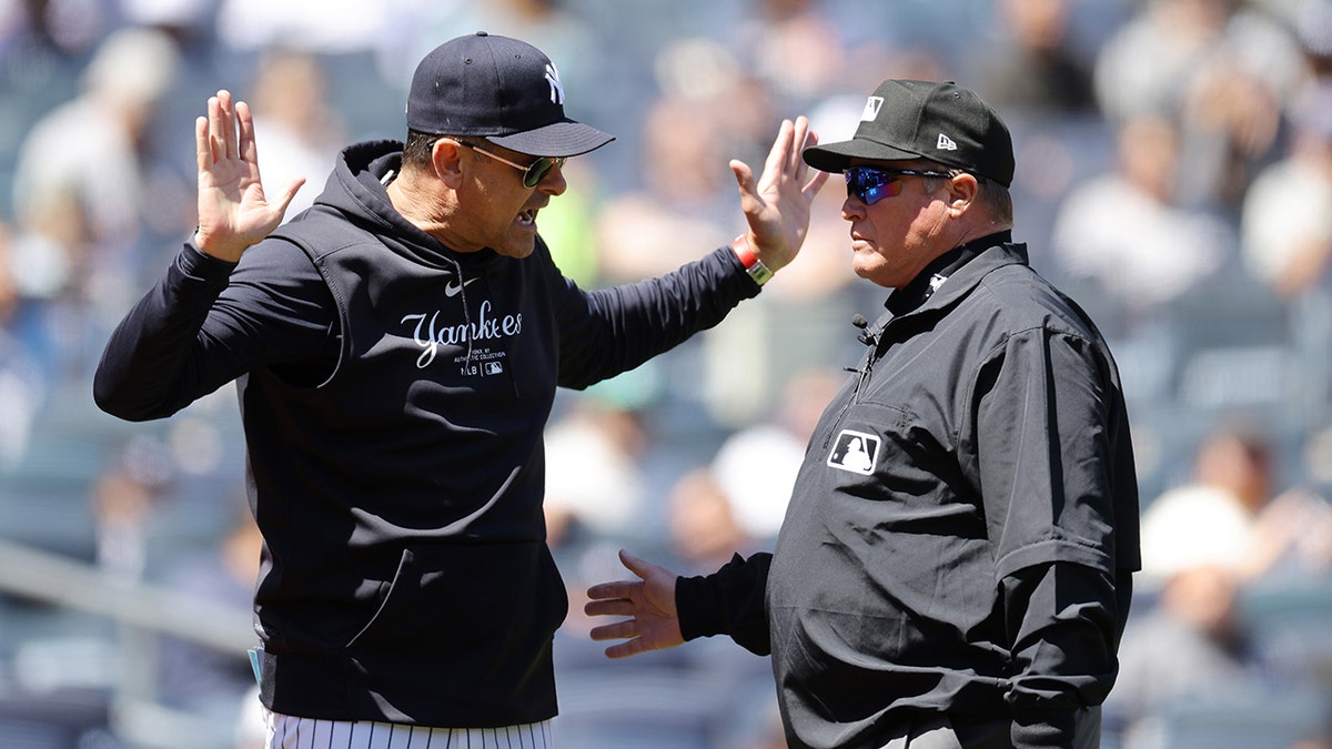 Aaron Boone talks with umpire