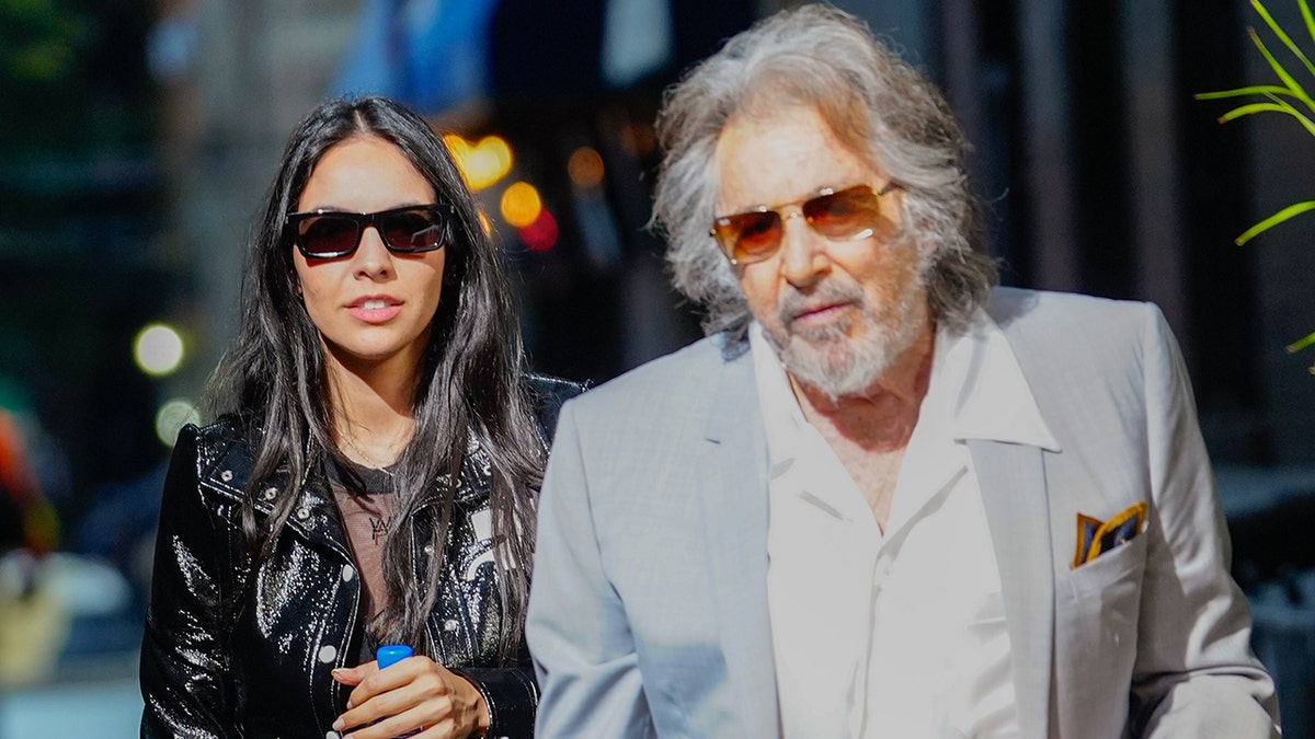 Al Pacino and Noor Alfallah walking together