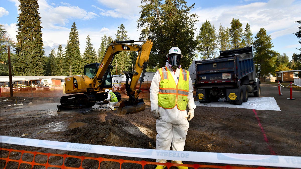 Environmental cleanup specialists work at an asbestos cleanup site in Libby, Montana