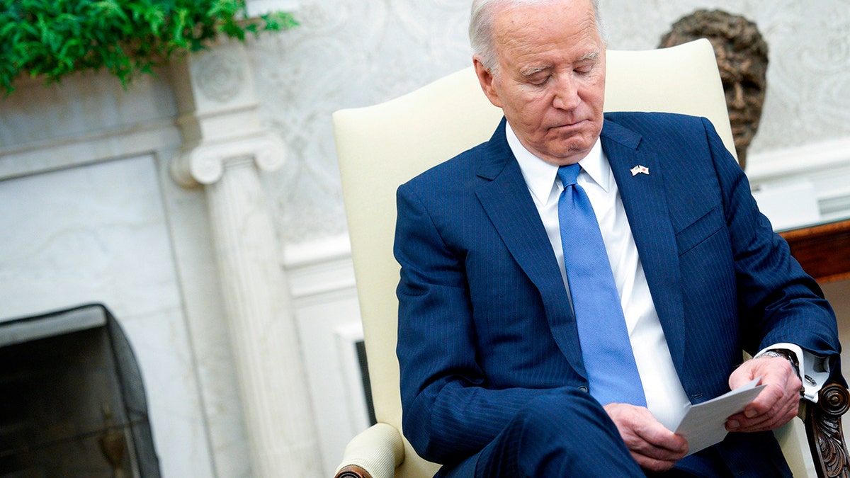 Biden looking at notes