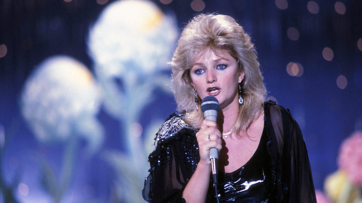 Bonnie Tyler singing into a microphone in the 1980s