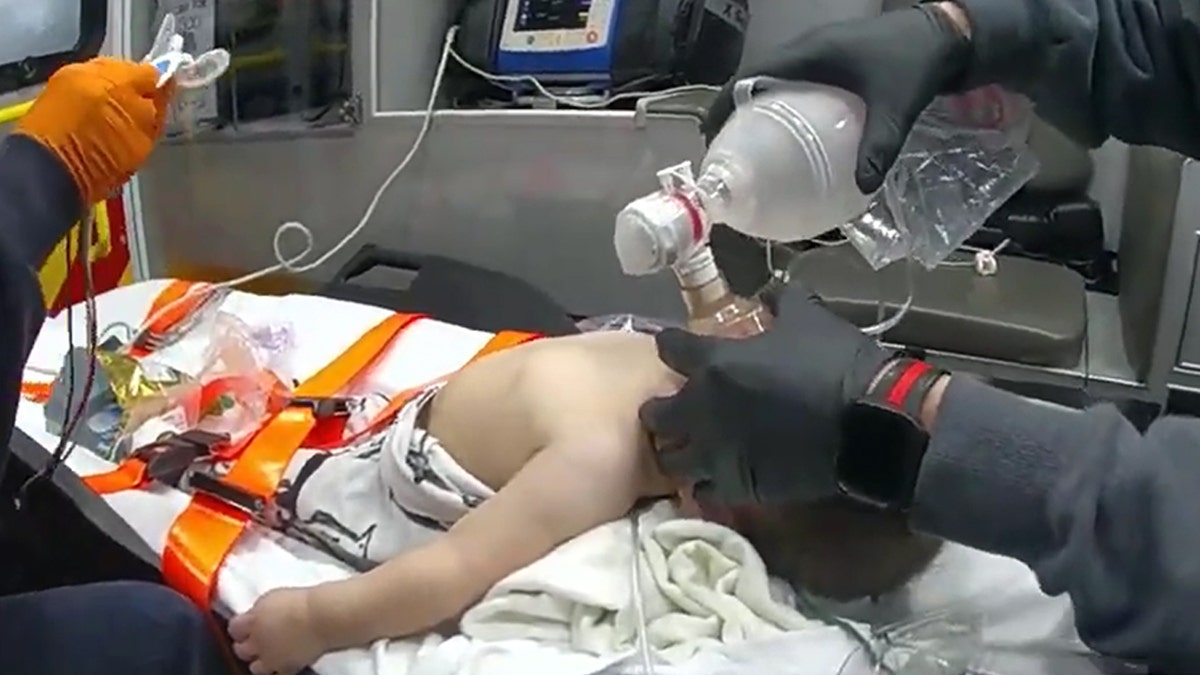 EMT holds breathing instrumentality complete infant's rima and nostrils