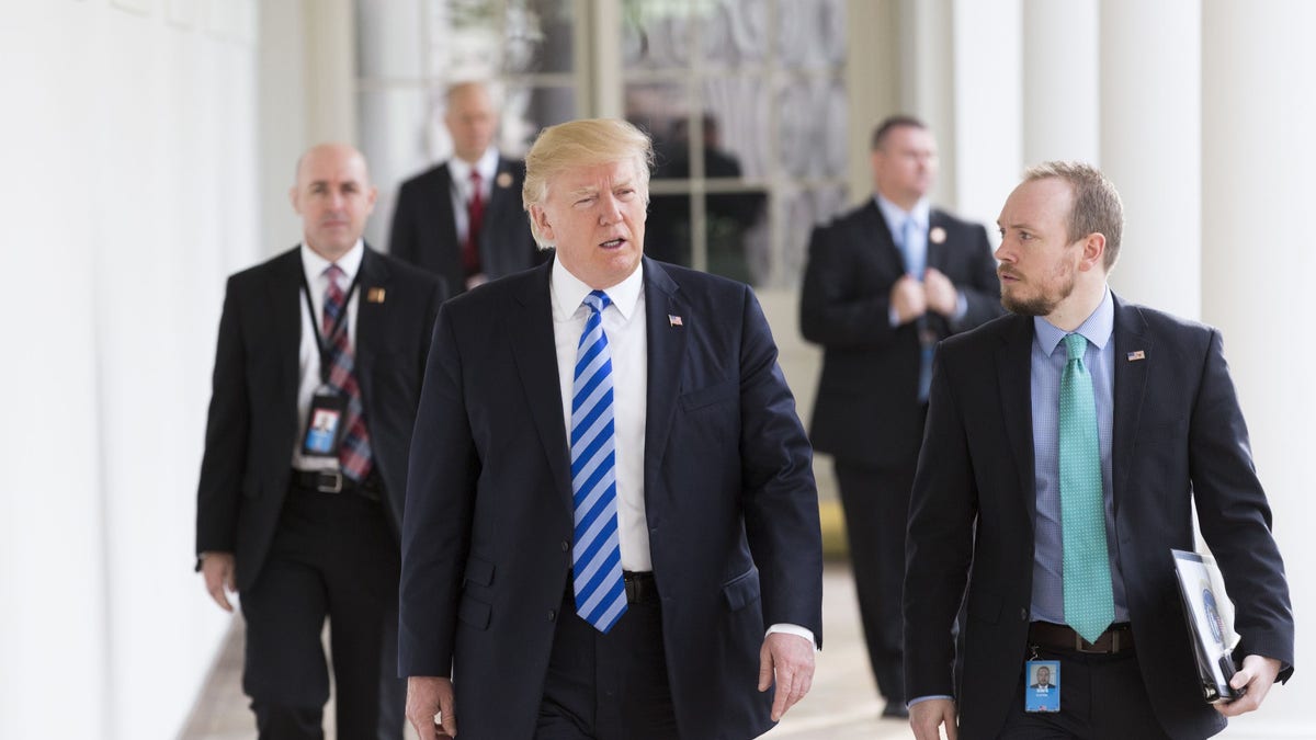 Former Special Assistant to the President and Deputy Director of National Intelligence for Strategy & Communications Cliff Sims walks with President Donald Trump down the west colonnade of the White House. (Official White House Photo By Shealah Craighead)