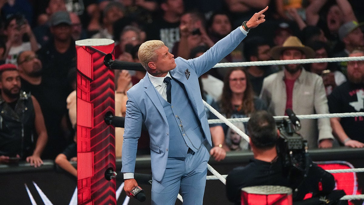 Cody Rhodes points to the WrestleMania banner