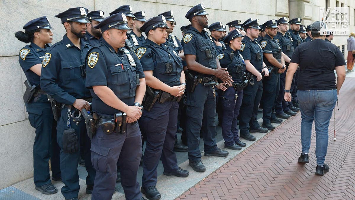 NYPD officers lined against building at Columbia University