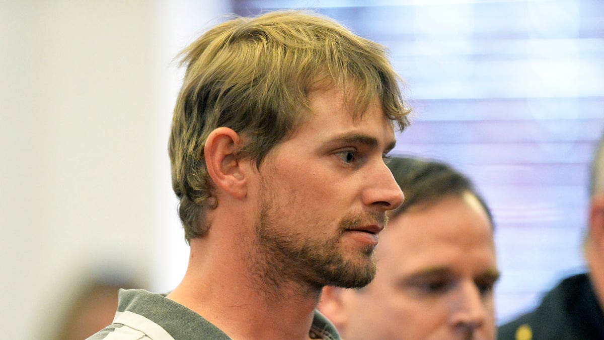 Ronnie Adrian "Jay" Towns wears a black and white striped shirt in his first courtroom appearance