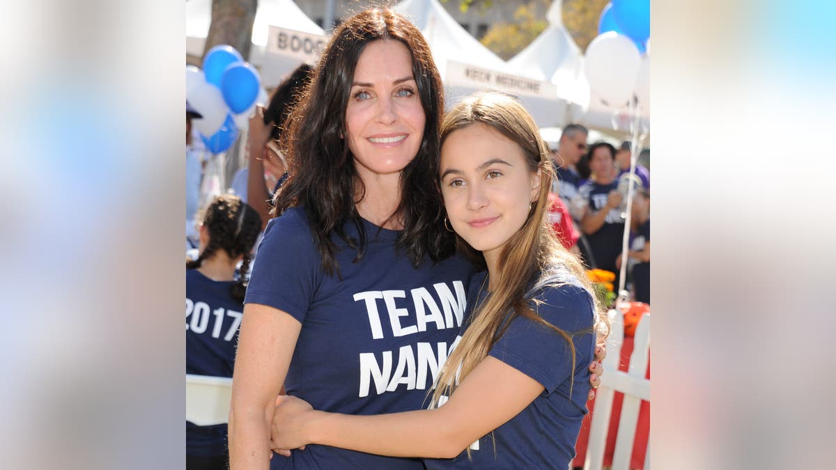 Coco Arquette giving Courteney Cox a hug