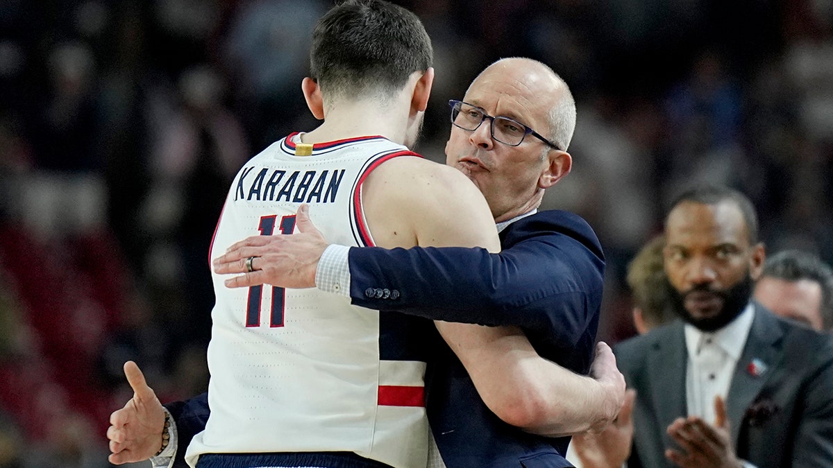 Dan Hurley hugs Alex Karaban