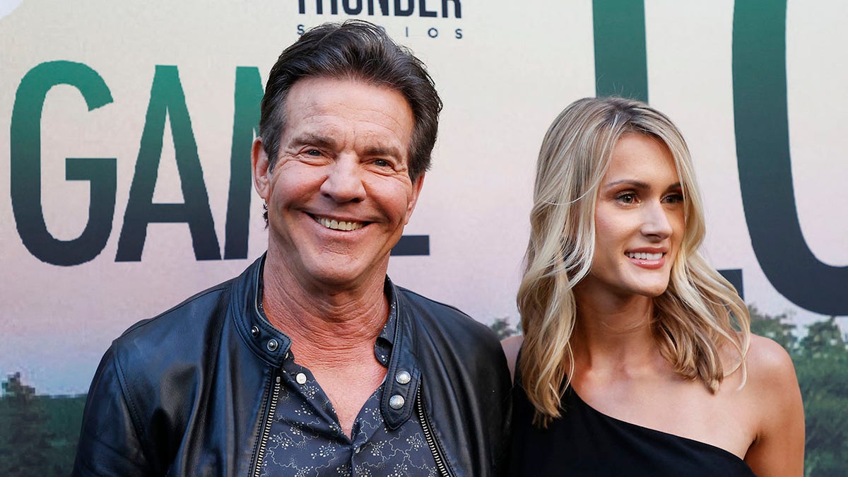 Dennis Quaid and Laura Savoie smiling on the red carpet