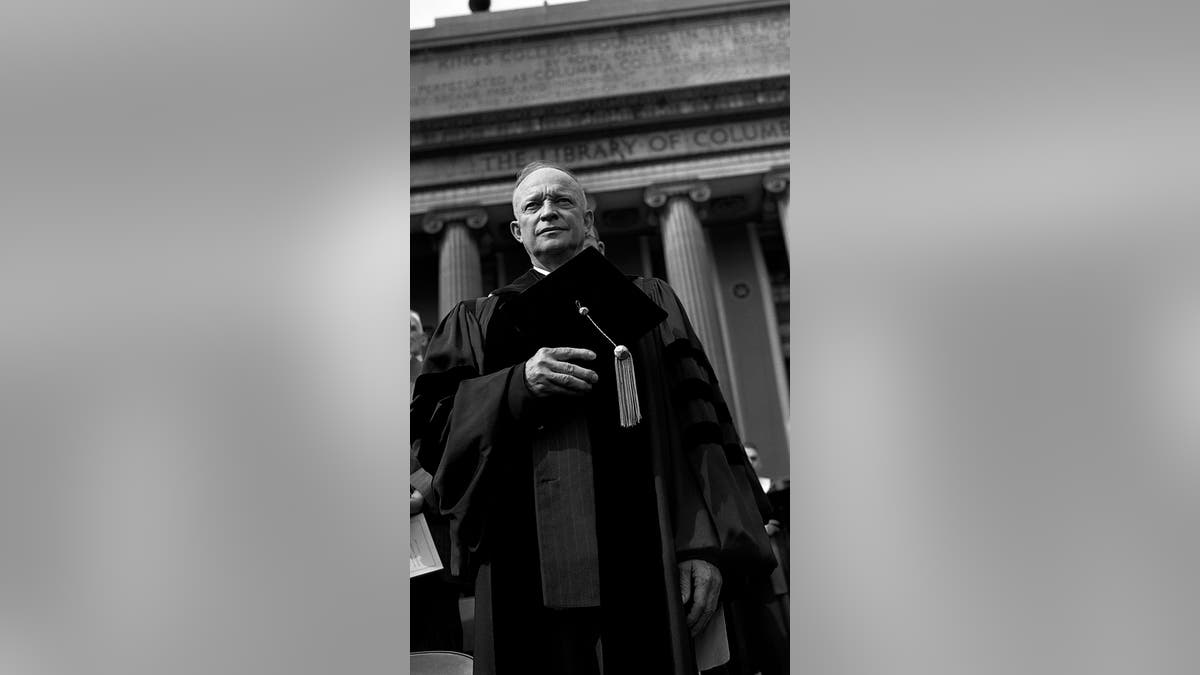 Dwight D. Eisenhower poses for a representation    successful  his headdress  and gown earlier  his Inauguration to go  President of Columbia University