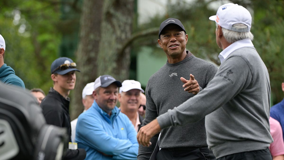 Tiger Woods talks with Fred Couples