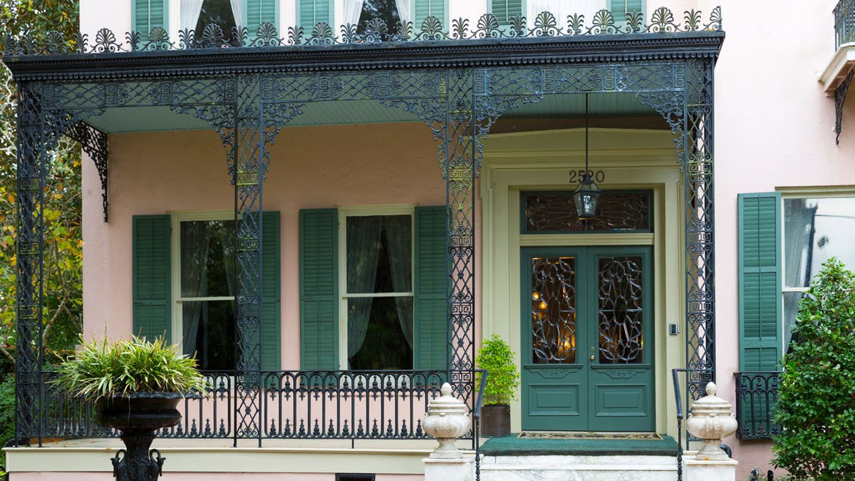 Traditional grand mansion house with wrought iron fretwork in the Garden District of New Orleans