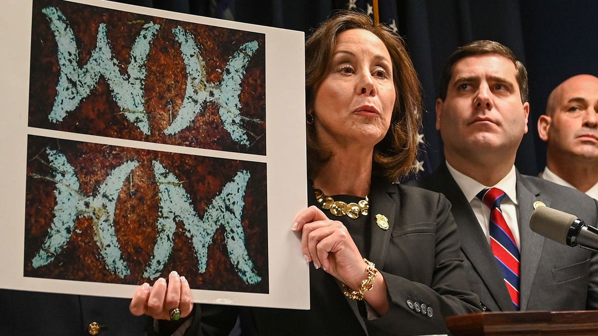 Geraldine Hart holds photo of belt