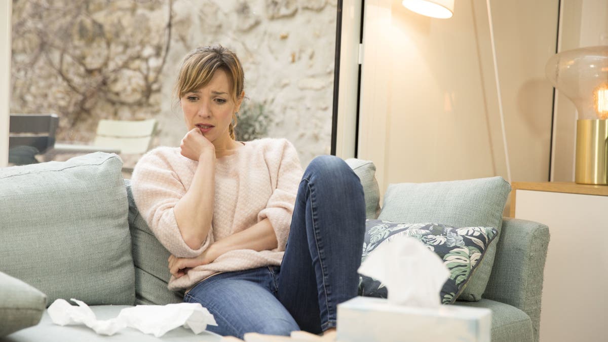 Sad woman sitting on a couch