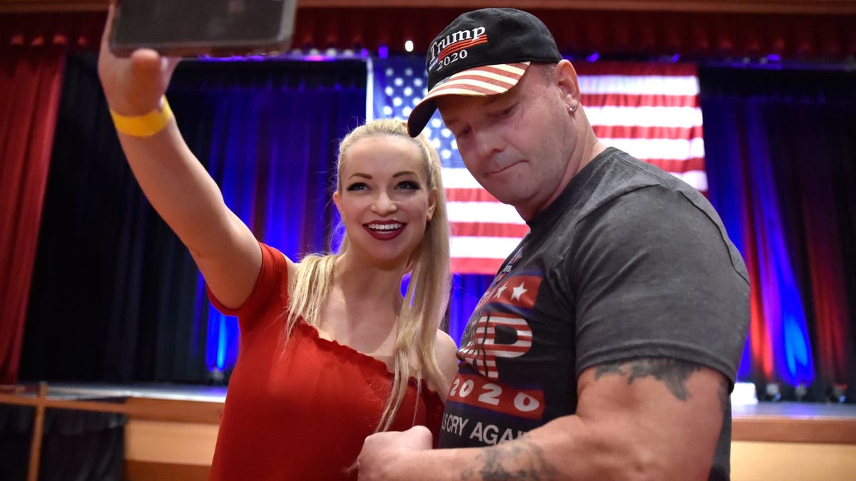 Mindy Robinson takes a selfie with John Wayne Bobbitt