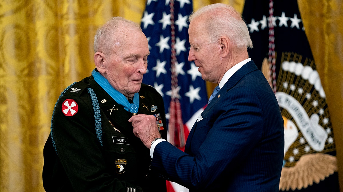 Biden holding the Medal of Honor