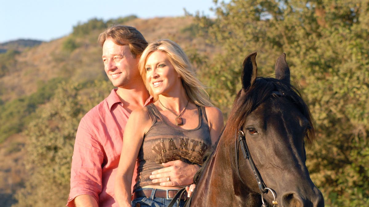 george peterson riding a horse with lauri peterson in RHOC