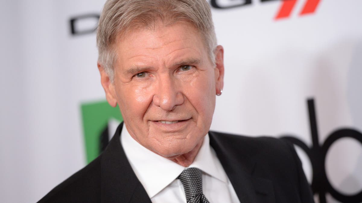 harrison ford on red carpet with hoop earring