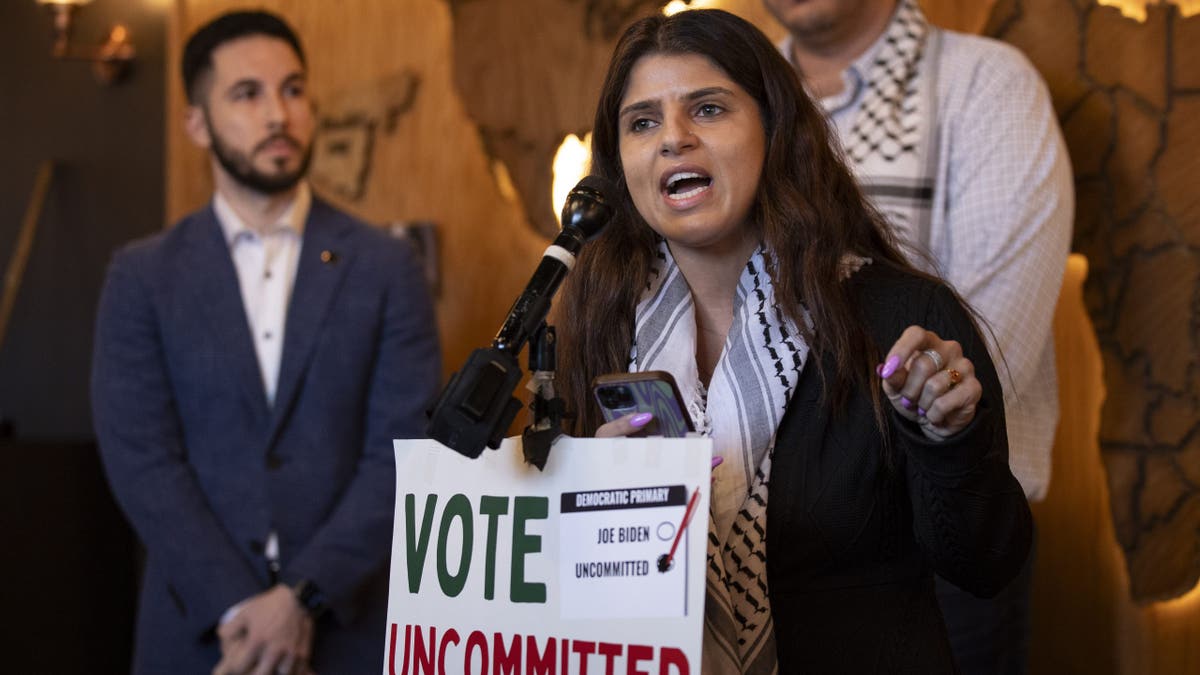 activist Lexis Zeidan, holding "vote uncommitted" sign