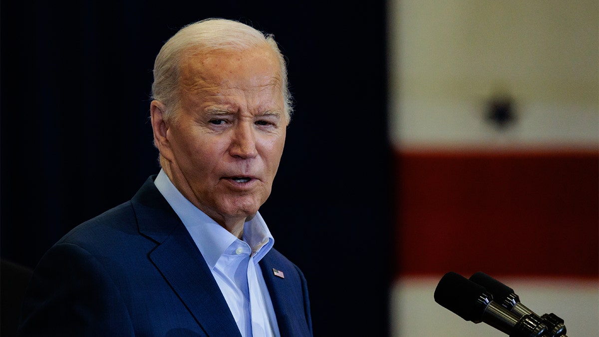 President Joe Biden in coat, blue shirt no tie