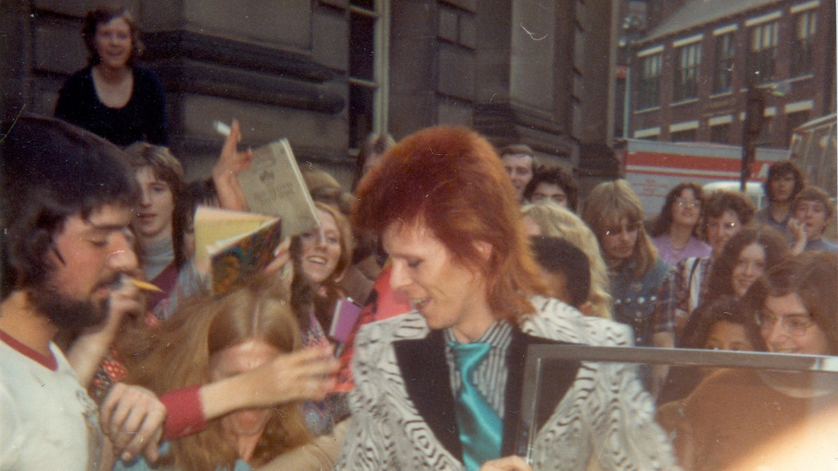 David Bowie being greeted by fans