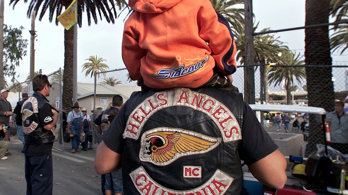 A Hells Angel member with child up on his shoulders