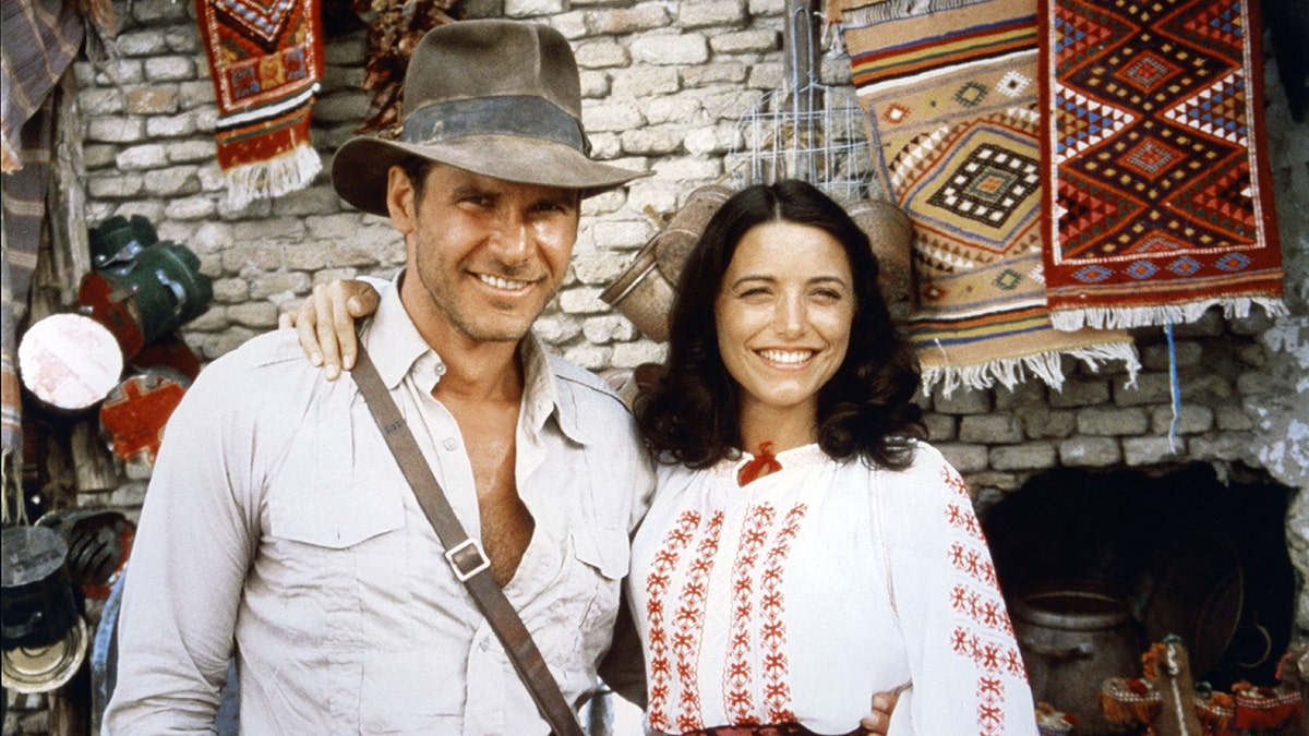 Karen smiling next to Harrison Ford as Indiana Jones