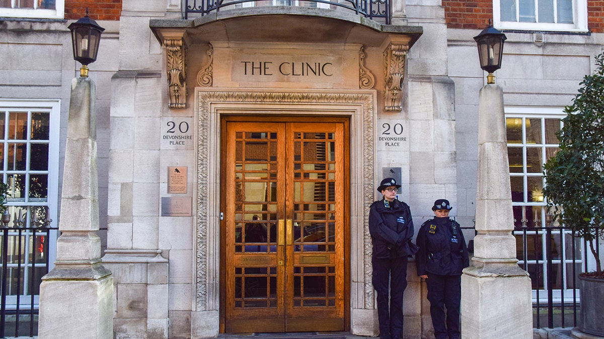 Two police officers standing outside the London Clinic