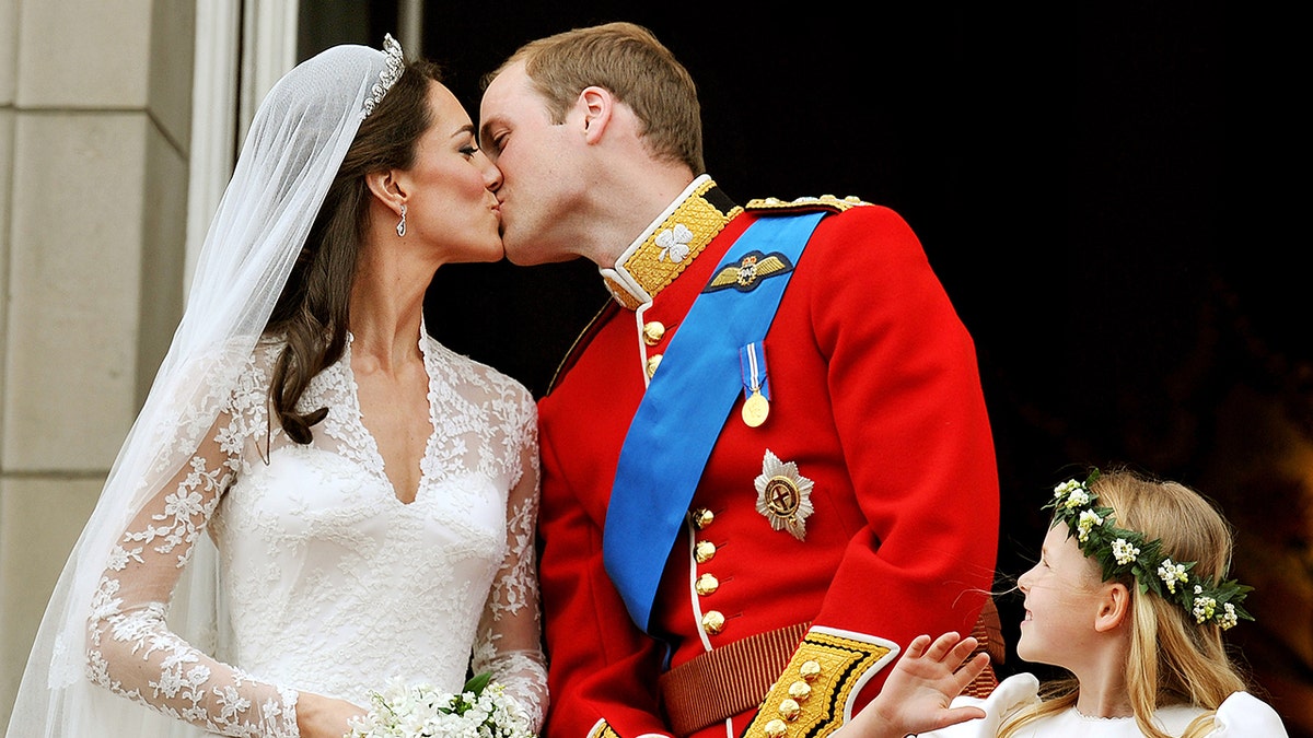 Prince William and Kate Middleton giving each other a kiss on their wedding day