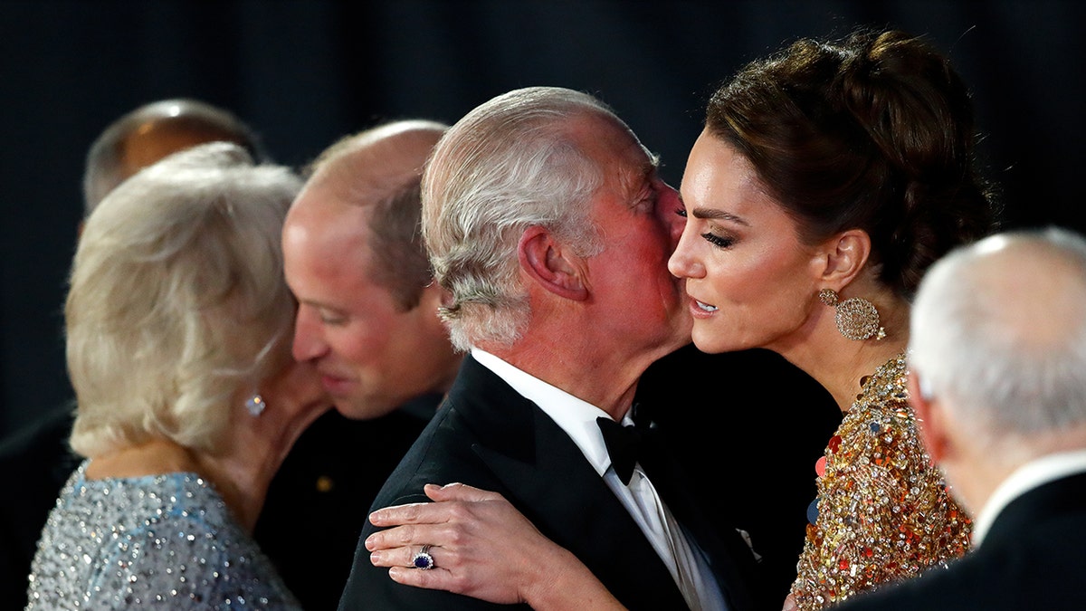 King Charles and Kate Middleton sharing a kiss on the cheek
