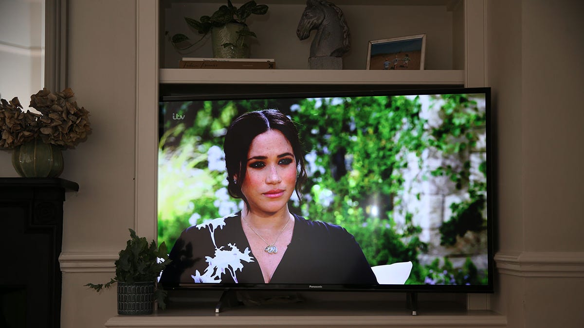 Meghan Markle looking serious from a TV screen