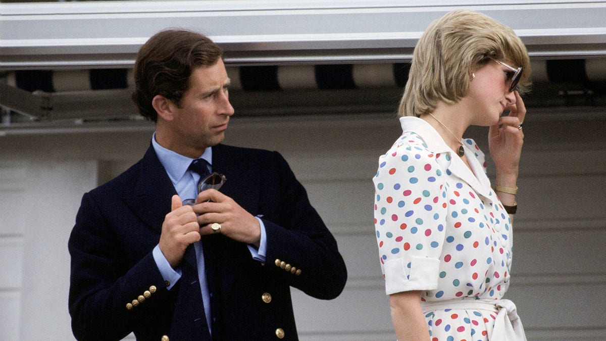 Prince Charles looking confused at Princess Diana as she has her back towards him