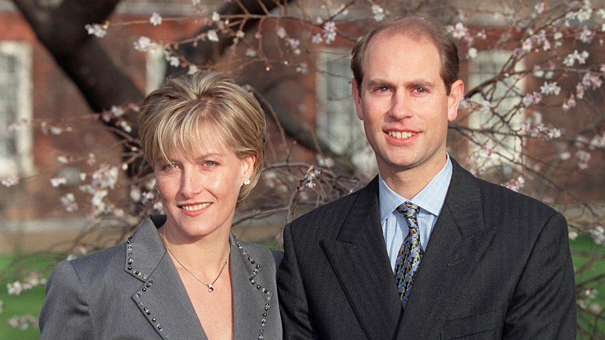 Prince Edward and Sophia standing together in front of a blossoming tree