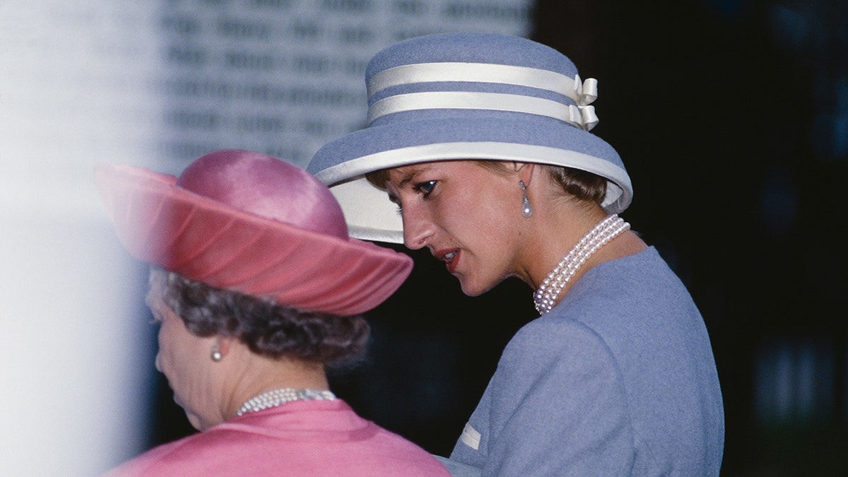Princess Diana looking down at Queen Elizabeth and speaking to her