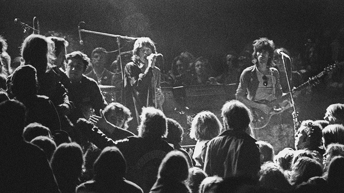 The Rolling Stones performing on stage, black and white photo