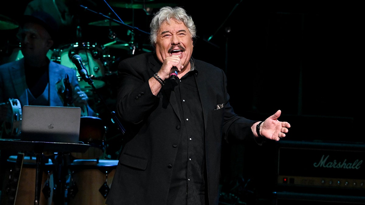 Tony Orlando singing to a mic