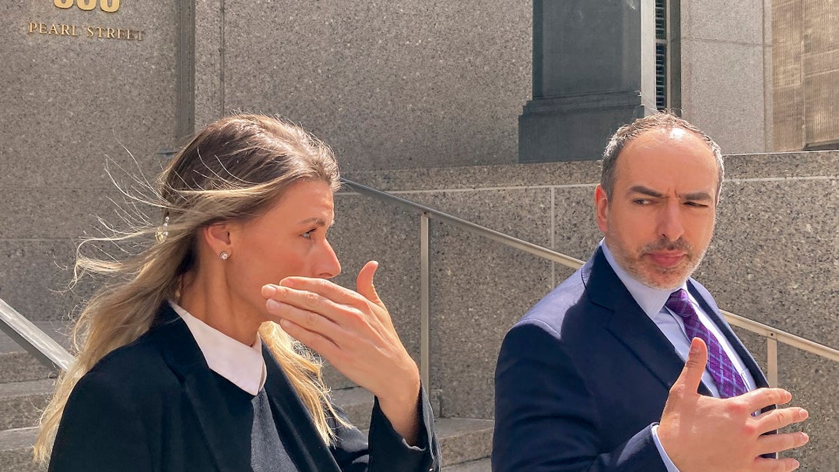 Aimee Harris with her attorney outside a New York courthouse