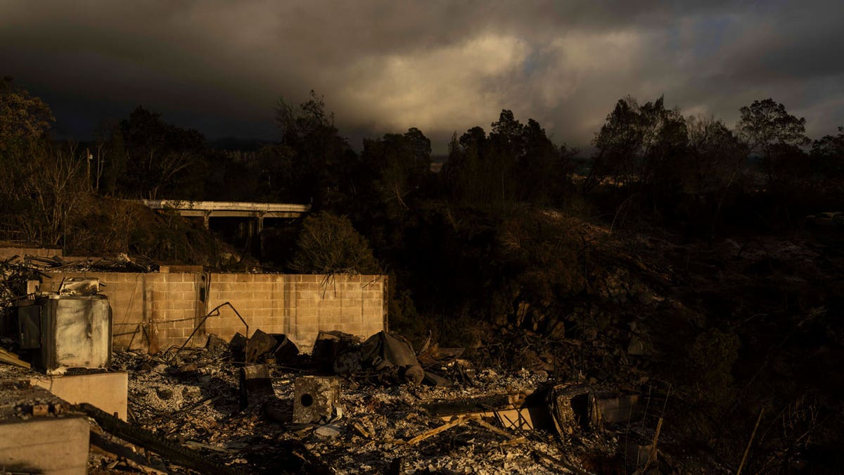 Clouds hang over a home destroyed in a wildfire in Kula, Hawaii