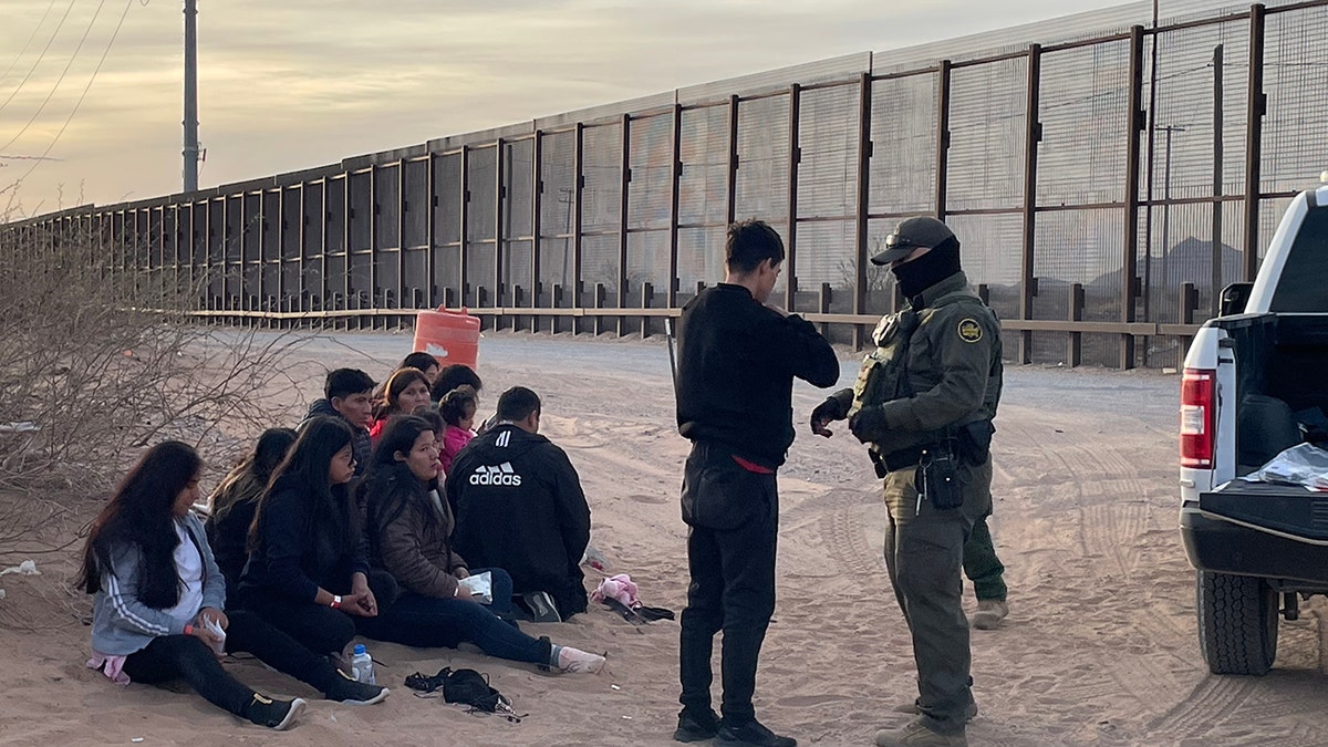 Migrants detained on ground near border by federal agents