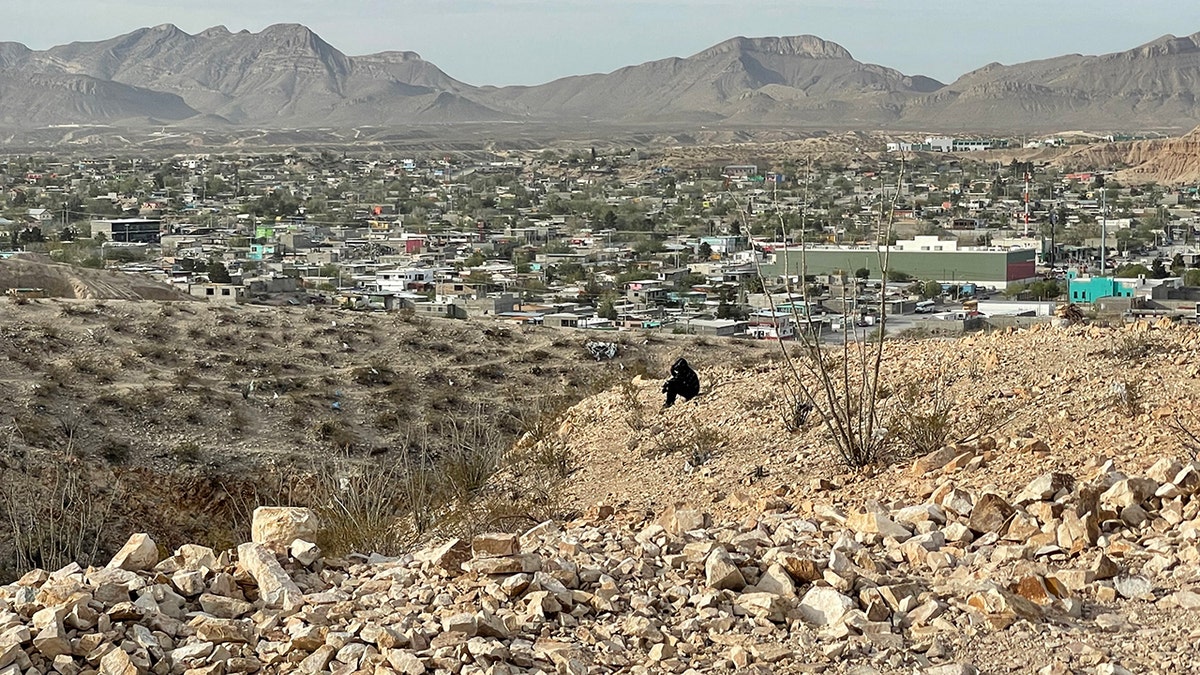 Border area with Mexico as migrant scout in black seen at center