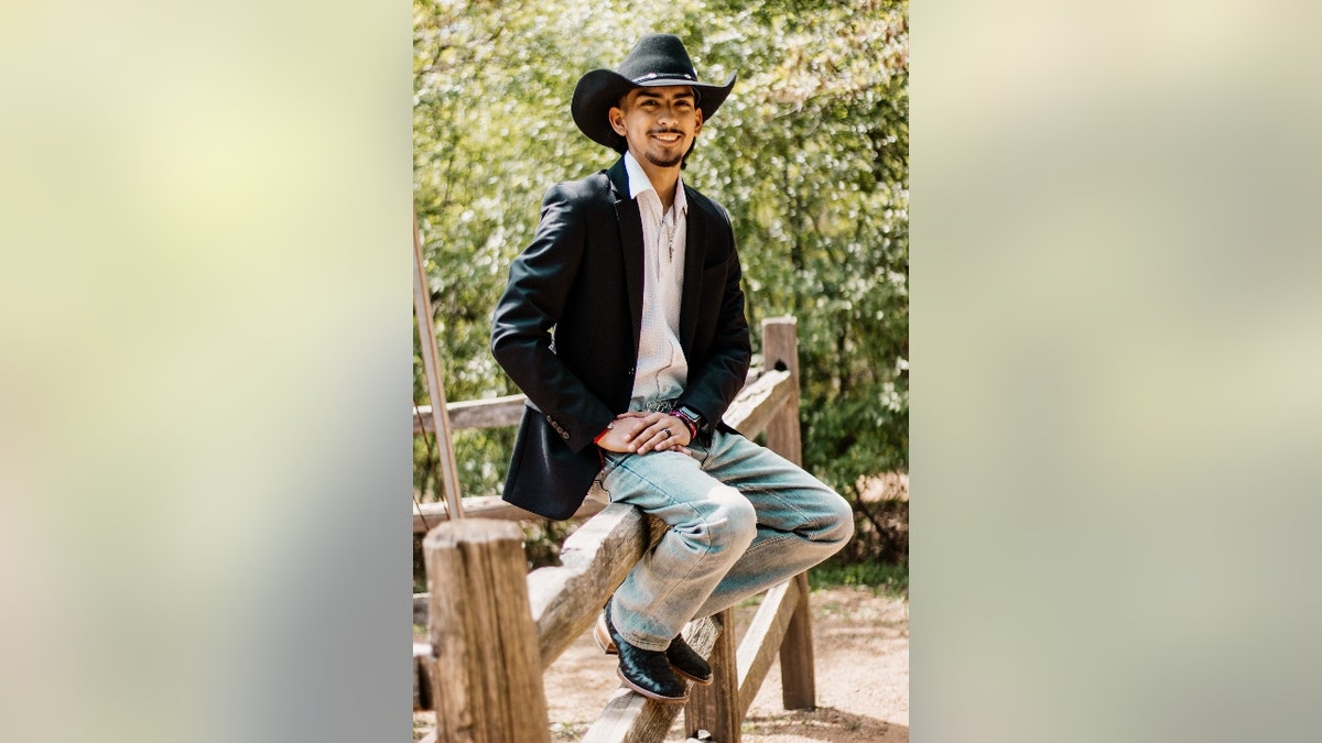 Carlos Laguna Jr. poses with a cowboy hat on