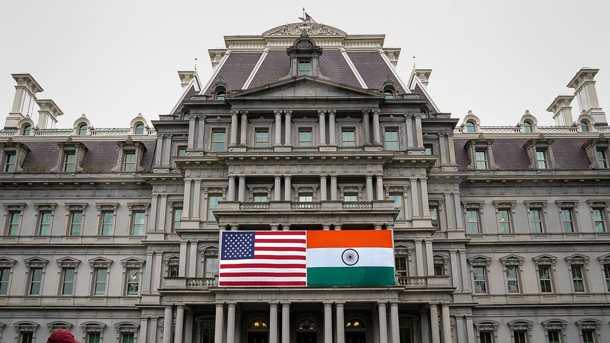 The flags of the United States and India are displayed
