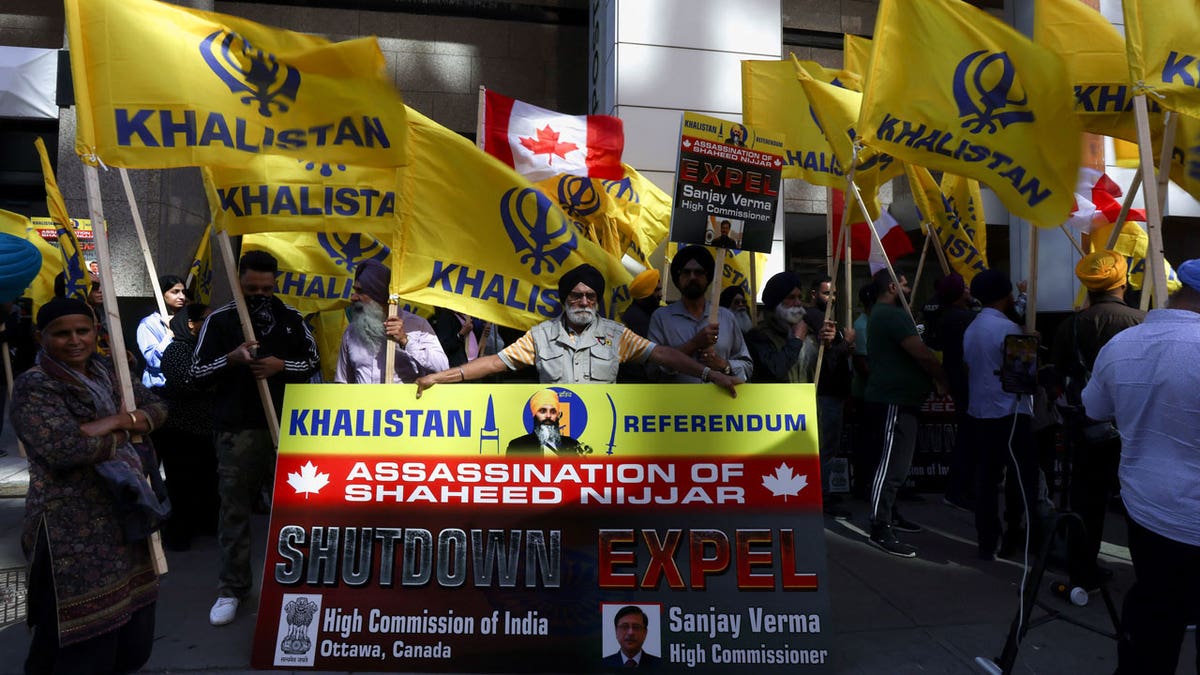 A group of protesters clasp yellowish flags pinch nan connection Khalistan, arsenic good arsenic a banner pinch nan image of Sikh separatist leader Hardeep Singh